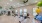 a gym with large windows, a tv, and exercise equipment