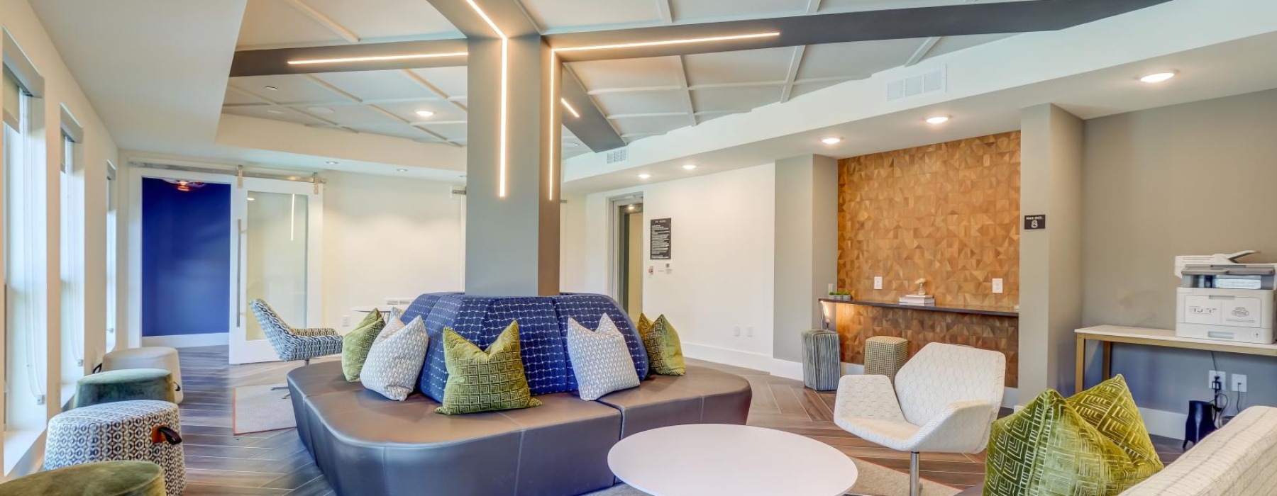 a lounge area with a couch and chairs