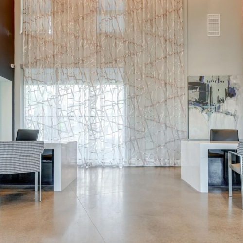 a room with chairs, tv's and tables