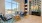 a lounge area with a big window and three couches